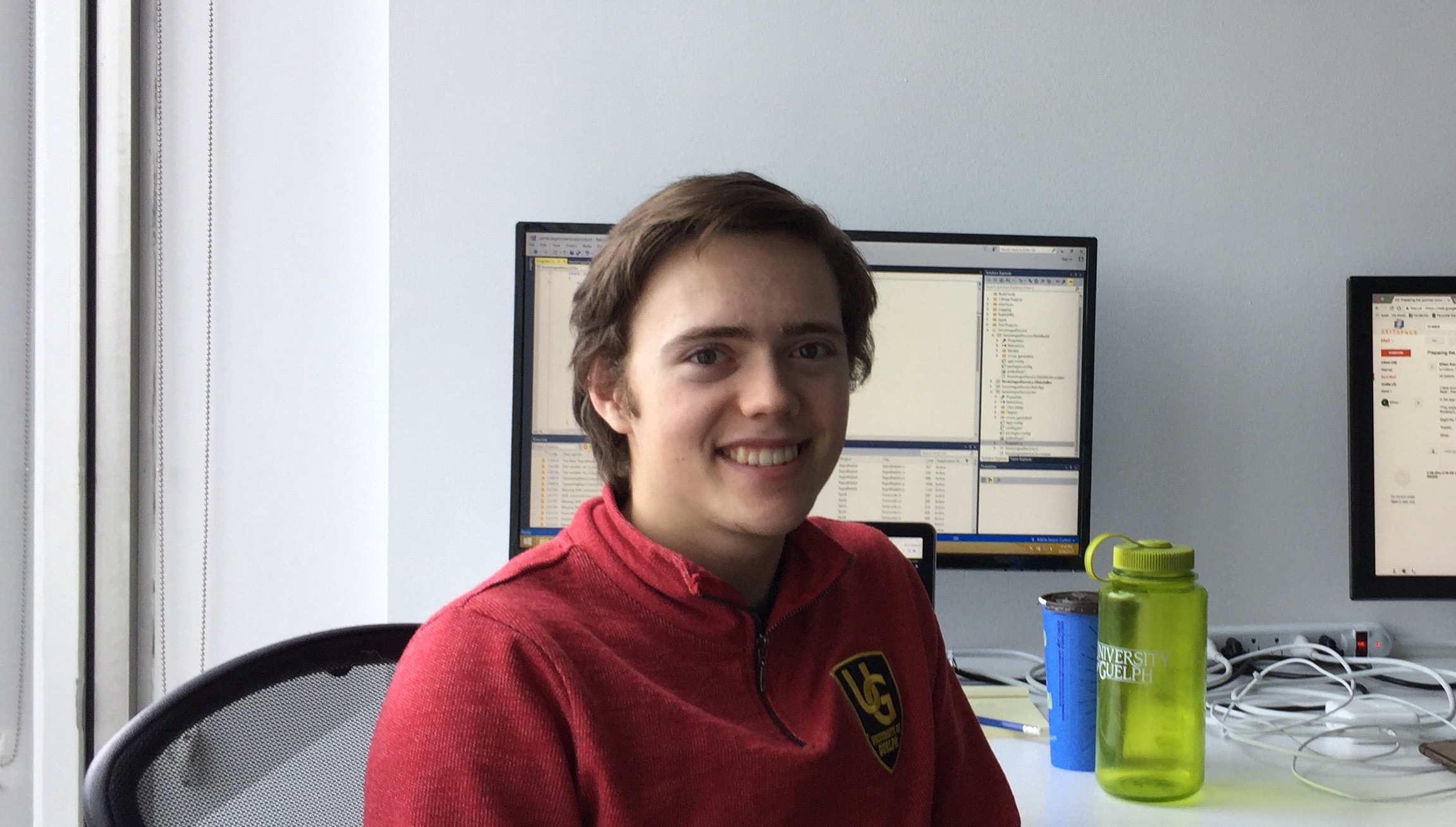 Kanoa in-front of his monitor in the Zeitspace Kitchener office