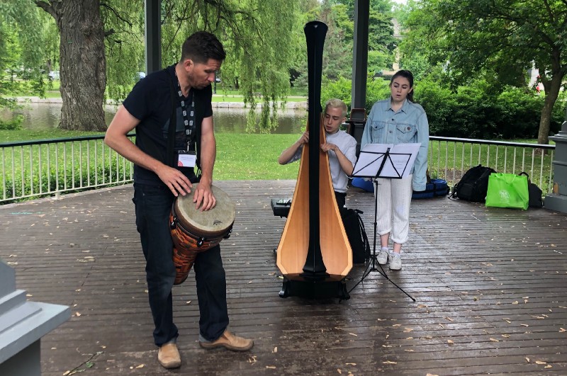 3 musicians perform in a park
