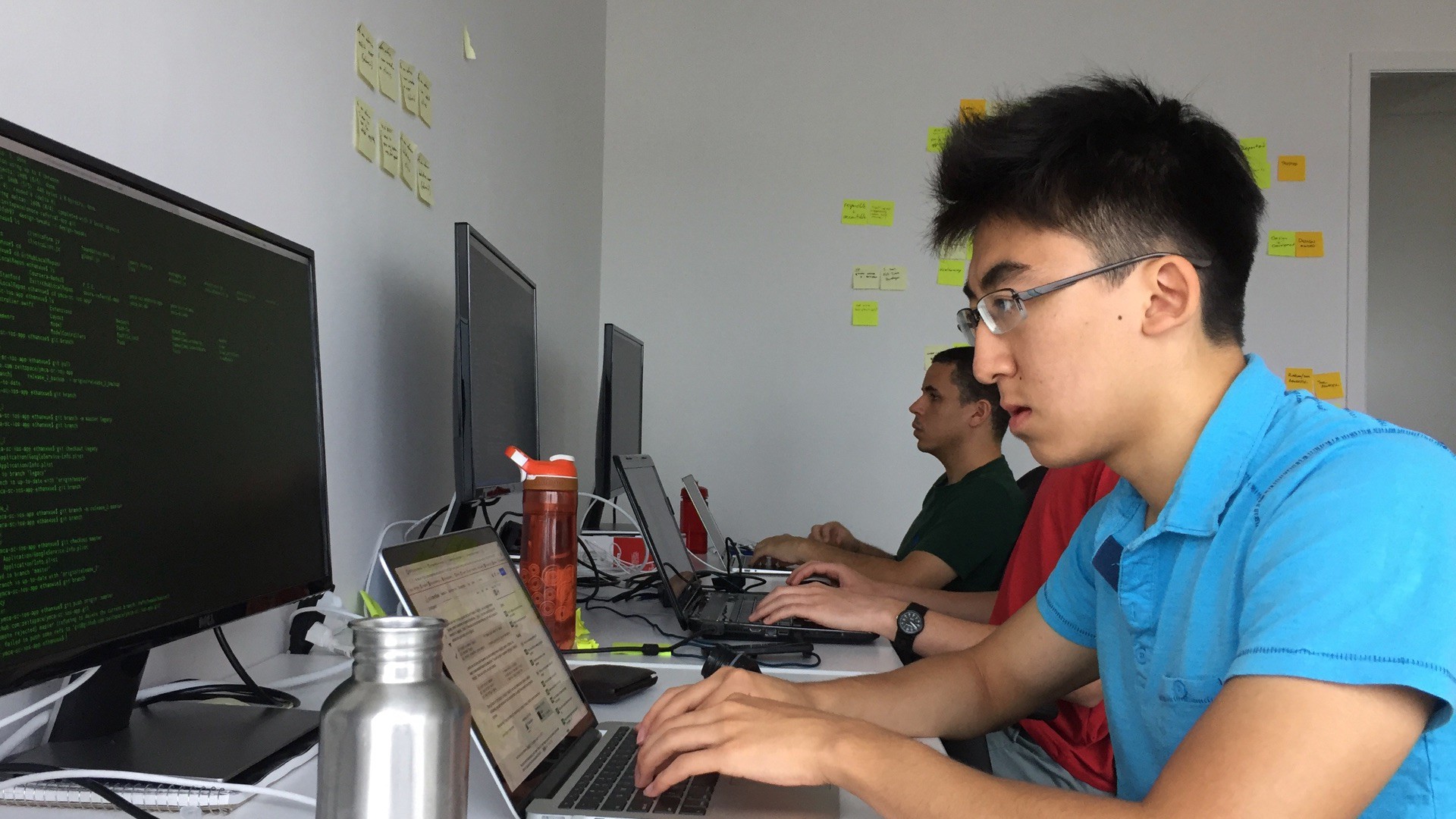 Ethan Xue working at his computer in the Zeitspace Kitchener office