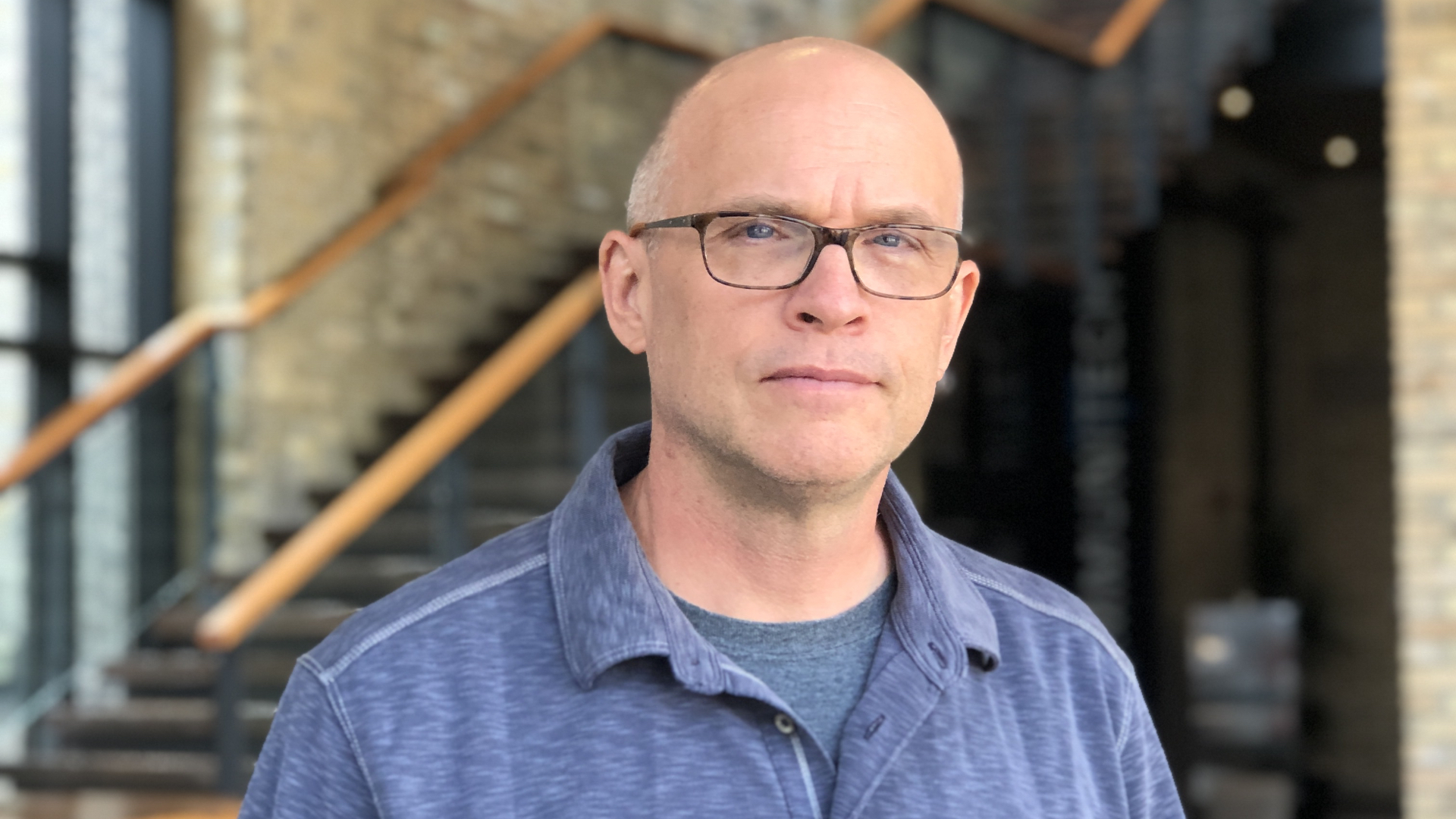 David Janik-Jones stands in front of a stair case in the Communitech building in Kitchener.