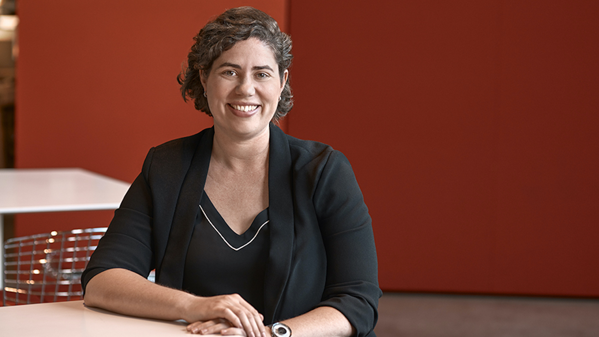 Design strategist Erin Corcoran sits at a desk.