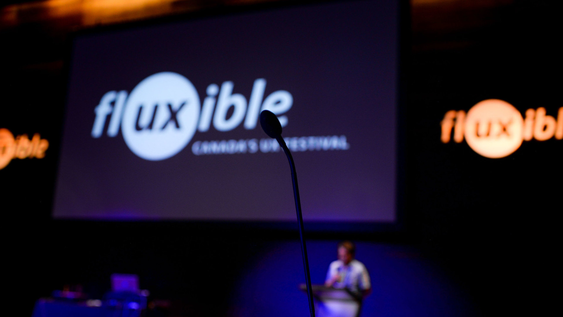 A mic with the Fluxible logo on a screen.