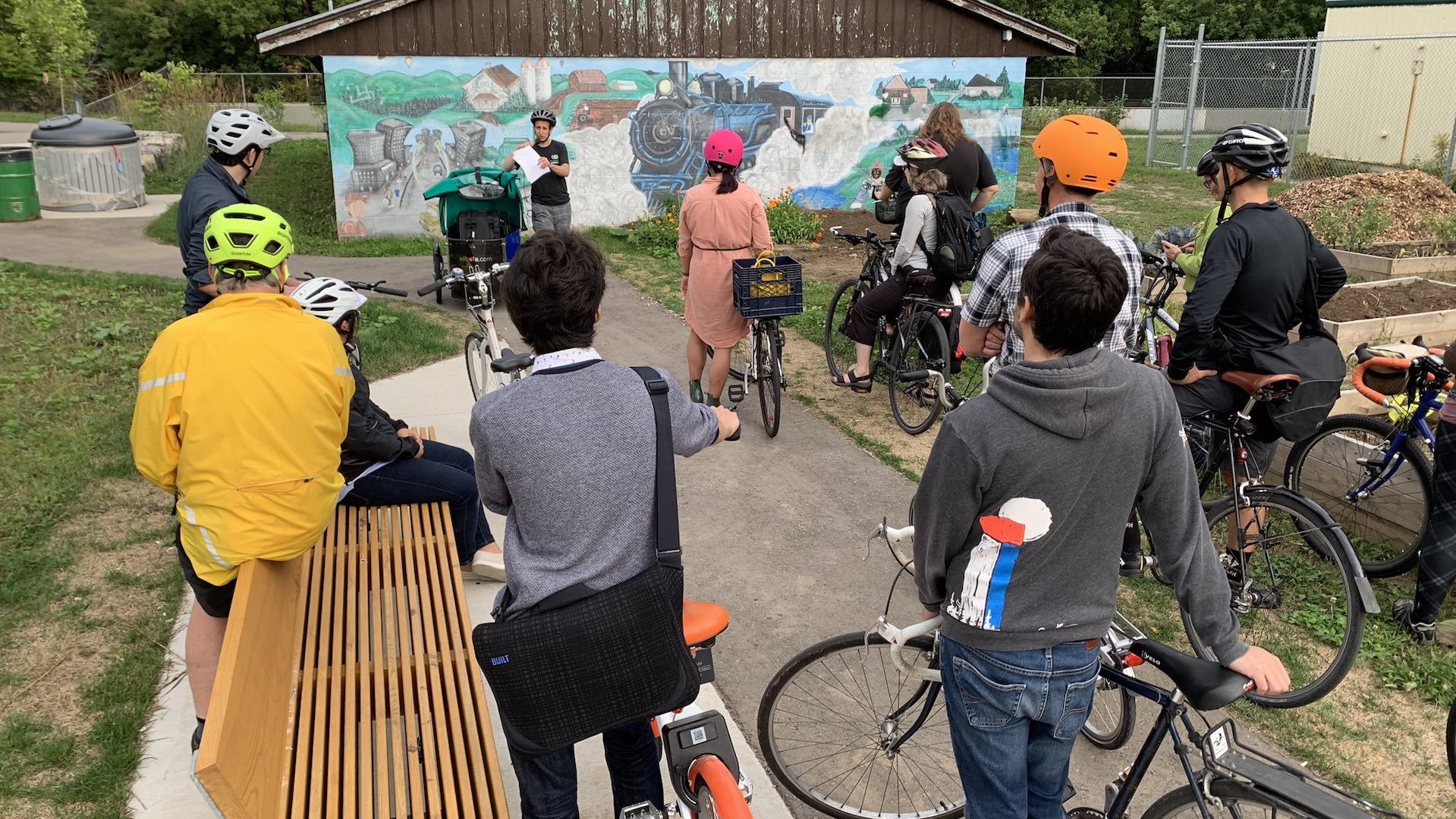 Darren Kropf speaks to participants of the Fluxible Guided Bike Tour about the Spur Line trail.