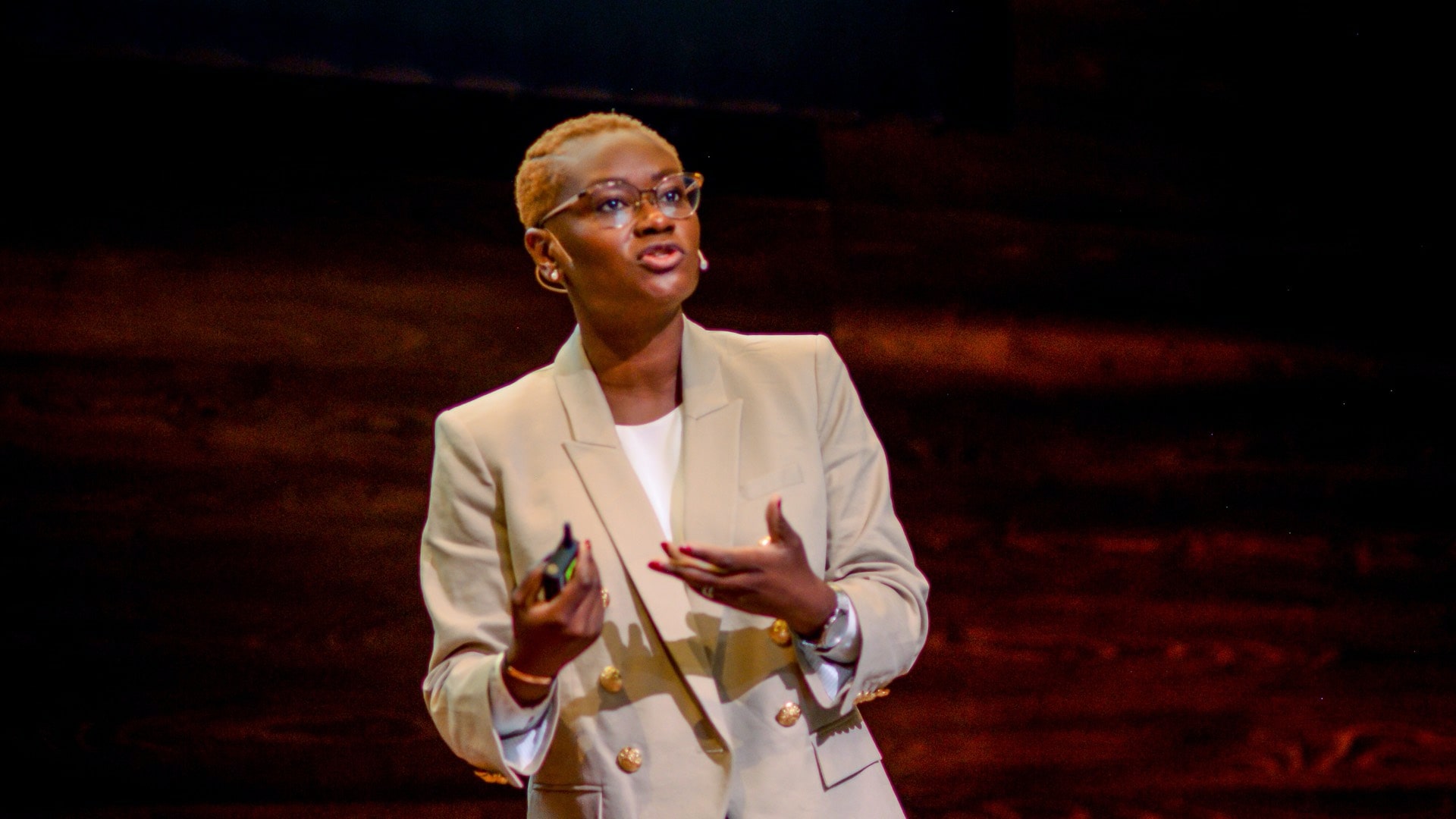 Lola Oyelayo-Pearson stands on a stage during Fluxible Conference.