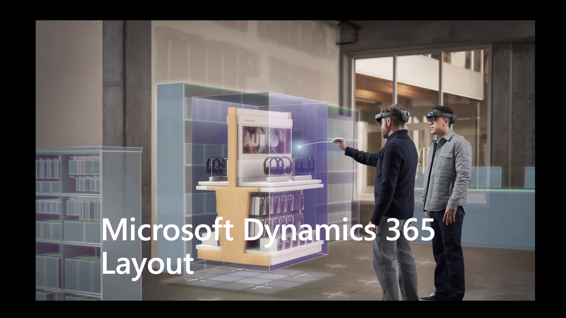 Two people wearing mixed reality headsets, one pointing at a hologram. Microsoft Dynamics 365 Layout written across the bottom.