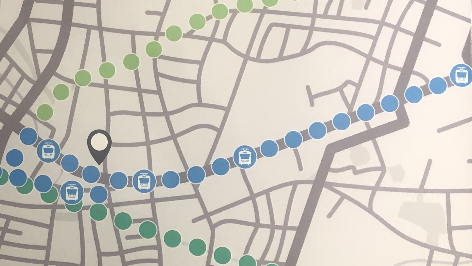 A map with blue, dark green, and light green dots indicating the LRT route, the Spurline Trail, and the Iron Horse Trail in Waterloo Region.