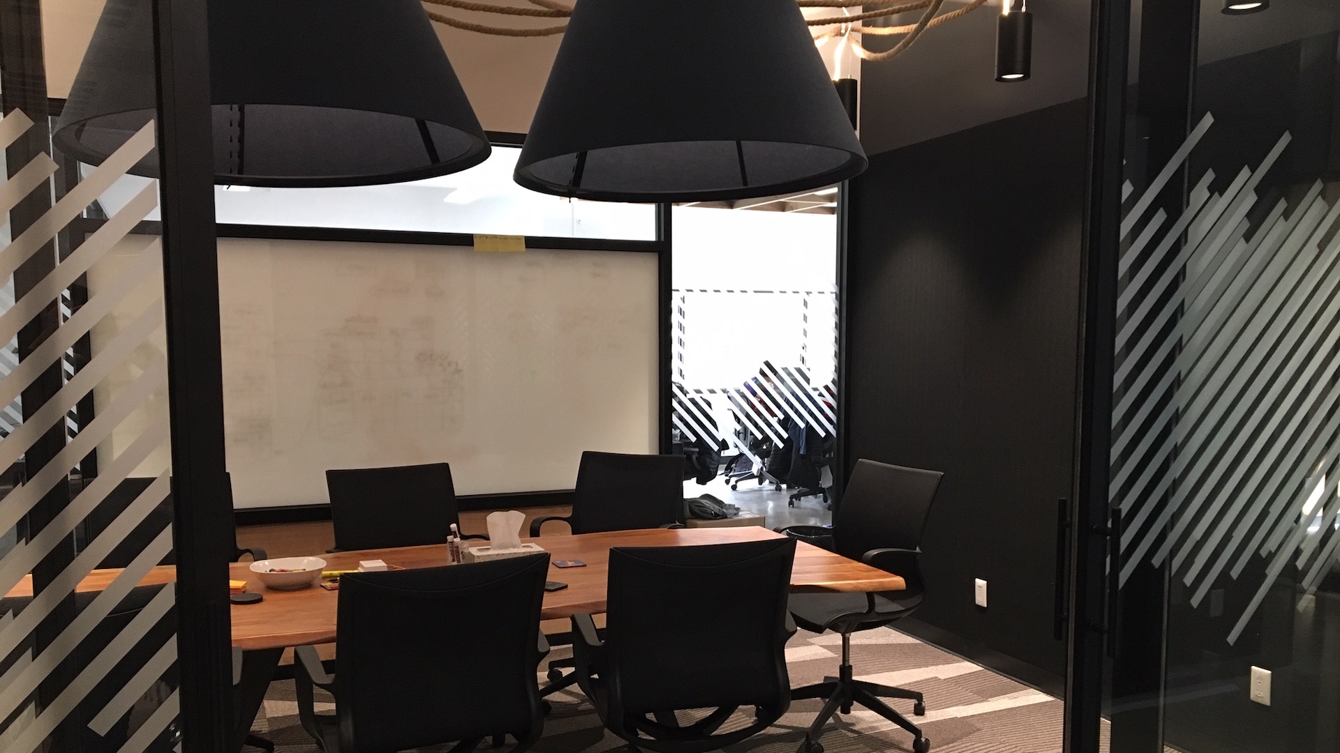 A photo of a Zeitspace meeting room with a table and whiteboards.