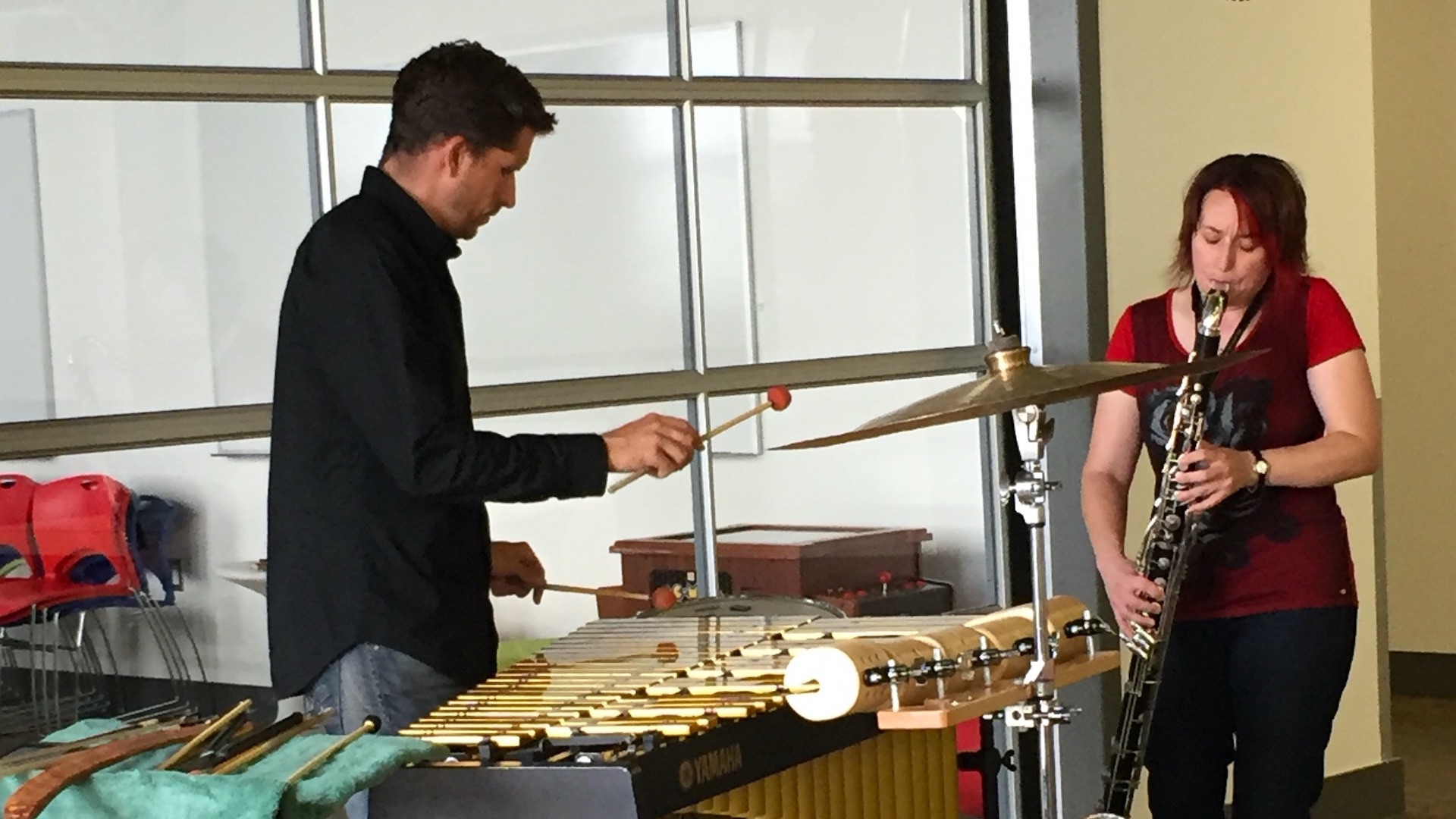 A man and woman playing musical instruments.