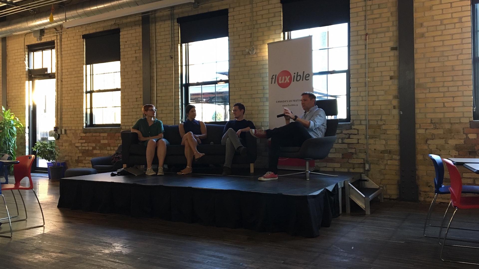 The panelists  Janice, Davis and Jeff K along with moderator Jeff on stage. The panelists are backlit :(