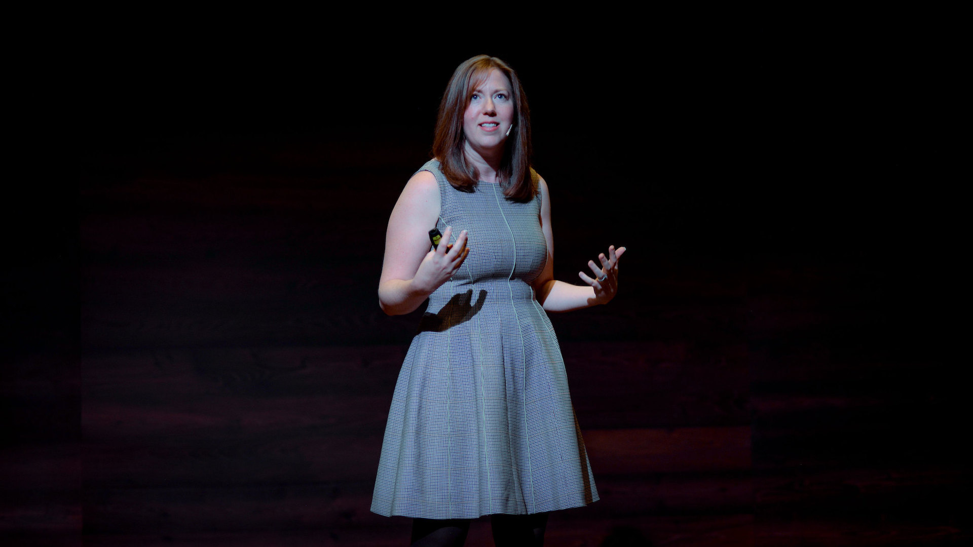 Margot Bloomstein stands on a stage during Fluxible.