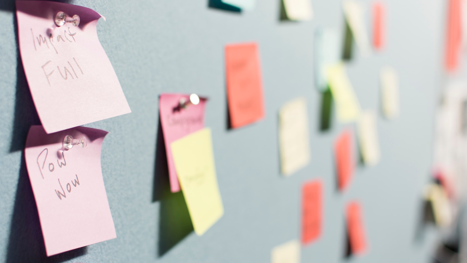 Various colors of Post-it Notes on a wall